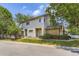 Charming gray two-story townhome showcasing brick accents, mature landscaping, and assigned parking in a desirable community at 2238 S Nome Ct, Aurora, CO 80014