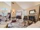 Warm and inviting living room featuring a fireplace, hardwood floors, and seamless flow to dining and living spaces at 2238 S Nome Ct, Aurora, CO 80014