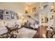 Bright living room with an open staircase, elegant decor, hardwood flooring, and ample natural light at 2238 S Nome Ct, Aurora, CO 80014