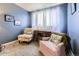 Cozy sitting room with soft lighting, comfortable armchairs, and sheer curtains on the window at 2238 S Nome Ct, Aurora, CO 80014