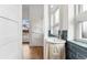 Bathroom featuring modern fixtures, blue backsplash, and light-filled space at 2038 Meade St, Denver, CO 80211