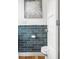 Stylish bathroom with blue subway tile, modern fixtures, and neutral accents at 2038 Meade St, Denver, CO 80211