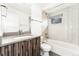 Bright bathroom featuring modern vanity, white tile, and combined shower and tub at 2038 Meade St, Denver, CO 80211