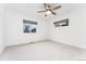 Bright bedroom featuring neutral walls, carpet, modern ceiling fan and two large windows at 2038 Meade St, Denver, CO 80211