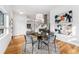 Dining area with an open layout to the kitchen, hardwood floors, and white walls at 2038 Meade St, Denver, CO 80211