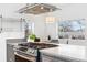 Bright kitchen with stainless steel range, light countertops, pendant lighting, and large windows at 2038 Meade St, Denver, CO 80211