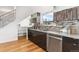 Modern kitchen featuring stainless steel appliances, stylish cabinetry, and beautiful backsplash at 2038 Meade St, Denver, CO 80211