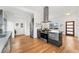 Modern kitchen featuring sleek countertops, stainless steel appliances, and wood floors at 2038 Meade St, Denver, CO 80211