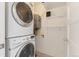 Laundry room with stacked washer and dryer and white shelving at 2038 Meade St, Denver, CO 80211