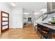 Open-concept living area with hardwood floors, white walls, and modern staircase at 2038 Meade St, Denver, CO 80211