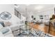 Bright, airy living room with hardwood floors, stylish furniture, and modern staircase at 2038 Meade St, Denver, CO 80211