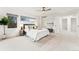 Staged bedroom showcases neutral walls and decor, carpet, ceiling fan and ample sunlight from the windows at 2038 Meade St, Denver, CO 80211