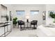 Staged and decorated bedroom showcases neutral walls and decor, carpet and ample sunlight from the windows at 2038 Meade St, Denver, CO 80211