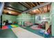 Unfinished basement featuring exposed beams, a window and painted green walls at 3795 W 104Th Dr # E, Westminster, CO 80031
