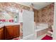 Cozy bathroom featuring a shower, bathtub and vanity with decorative wallpaper at 3795 W 104Th Dr # E, Westminster, CO 80031