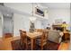 Inviting dining area with a fireplace, wooden table, and view of the upper level at 3795 W 104Th Dr # E, Westminster, CO 80031
