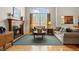 Cozy living room featuring a fireplace, hardwood floors, and neutral-toned furniture at 3795 W 104Th Dr # E, Westminster, CO 80031