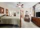 Comfortable main bedroom featuring a ceiling fan, a sitting area with recliner, and access to the closet and bathroom at 3795 W 104Th Dr # E, Westminster, CO 80031