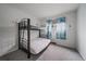 Bedroom with bunkbeds, carpeted floor and a window with blue curtains at 7917 Chase Cir # 160, Arvada, CO 80003
