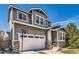 Beautiful gray two-story home featuring stone accents, an attached two-car garage, and a basketball hoop at 3024 Woodbriar Dr, Highlands Ranch, CO 80126