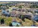 High-angle aerial image of a residential community featuring landscaped yards, tree-lined streets, and varied home styles at 22261 Pebble Brook Ln, Parker, CO 80138