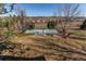 Large backyard featuring a sports court and fire pit area with seating and neighborhood views at 22261 Pebble Brook Ln, Parker, CO 80138