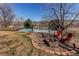 Picturesque backyard featuring a sports court and fire pit area with chairs for relaxing at 22261 Pebble Brook Ln, Parker, CO 80138