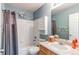 Small vintage-themed bathroom with a tub, shower, and vanity with storage at 22261 Pebble Brook Ln, Parker, CO 80138