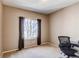 Bright, neutral-toned bedroom with large window and dark curtains; desk and chair sit in the corner at 22261 Pebble Brook Ln, Parker, CO 80138