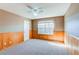 Cozy bedroom featuring natural wood paneling on the lower walls and carpeted floors at 22261 Pebble Brook Ln, Parker, CO 80138