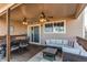 Cozy covered deck features dining area, comfortable wicker seating, and outdoor ceiling fans, perfect for entertaining at 22261 Pebble Brook Ln, Parker, CO 80138