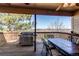 Relaxing covered deck features a grill, dining table and chairs, and open views; perfect for al fresco dining at 22261 Pebble Brook Ln, Parker, CO 80138
