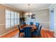 Elegant dining room with hardwood floors, stylish chandelier, and ample natural light at 22261 Pebble Brook Ln, Parker, CO 80138