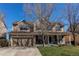 Inviting home with a well-manicured lawn, covered porch, and a two-car garage, perfect for families at 22261 Pebble Brook Ln, Parker, CO 80138