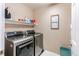 Functional laundry room with front load washer and dryer, shelf, and storage at 22261 Pebble Brook Ln, Parker, CO 80138