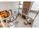Bright, two-story living room with fireplace, large windows, and neutral décor; adjacent to kitchen and breakfast nook at 22261 Pebble Brook Ln, Parker, CO 80138