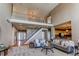 Expansive living area featuring a staircase, views to the entry, and an open layout at 22261 Pebble Brook Ln, Parker, CO 80138