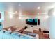Spacious living room with a large TV and comfortable seating, perfect for entertainment at 22261 Pebble Brook Ln, Parker, CO 80138