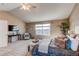Bright main bedroom featuring neutral tones, vaulted ceilings, and a decorative seating area near a sunny window at 22261 Pebble Brook Ln, Parker, CO 80138