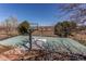 Outdoor sports court with basketball hoop and fencing surrounded by mature landscaping at 22261 Pebble Brook Ln, Parker, CO 80138