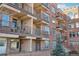 Brick apartment building with balconies and outdoor seating for residents to enjoy at 2700 E Cherry Creek South Dr # 216, Denver, CO 80209