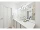 Bathroom featuring a sink with quartz countertop, large mirror, and access to a closet at 2700 E Cherry Creek South Dr # 216, Denver, CO 80209