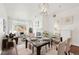Elegant dining room with glass table, seating for six, and a decorative light fixture at 2700 E Cherry Creek South Dr # 216, Denver, CO 80209