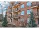Brick apartment building showing balconies with metal railings and several windows at 2700 E Cherry Creek South Dr # 216, Denver, CO 80209