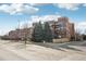 Exterior view of a brick apartment building on a sunny day at 2700 E Cherry Creek South Dr # 216, Denver, CO 80209