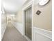 Well-lit hallway with neutral carpet and wall colors, and unit number 216 visible at 2700 E Cherry Creek South Dr # 216, Denver, CO 80209