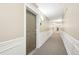 Neutral colored hallway showing doors to the living unit and a carpeted floor at 2700 E Cherry Creek South Dr # 216, Denver, CO 80209