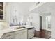 Open-concept kitchen with white cabinets, stainless steel appliances, and view of the living area at 2700 E Cherry Creek South Dr # 216, Denver, CO 80209