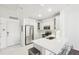 Well-lit kitchen with stainless steel appliances, sleek white cabinets, and a breakfast bar at 2700 E Cherry Creek South Dr # 216, Denver, CO 80209