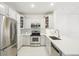 Bright kitchen with stainless steel appliances, white cabinets, and quartz countertops at 2700 E Cherry Creek South Dr # 216, Denver, CO 80209